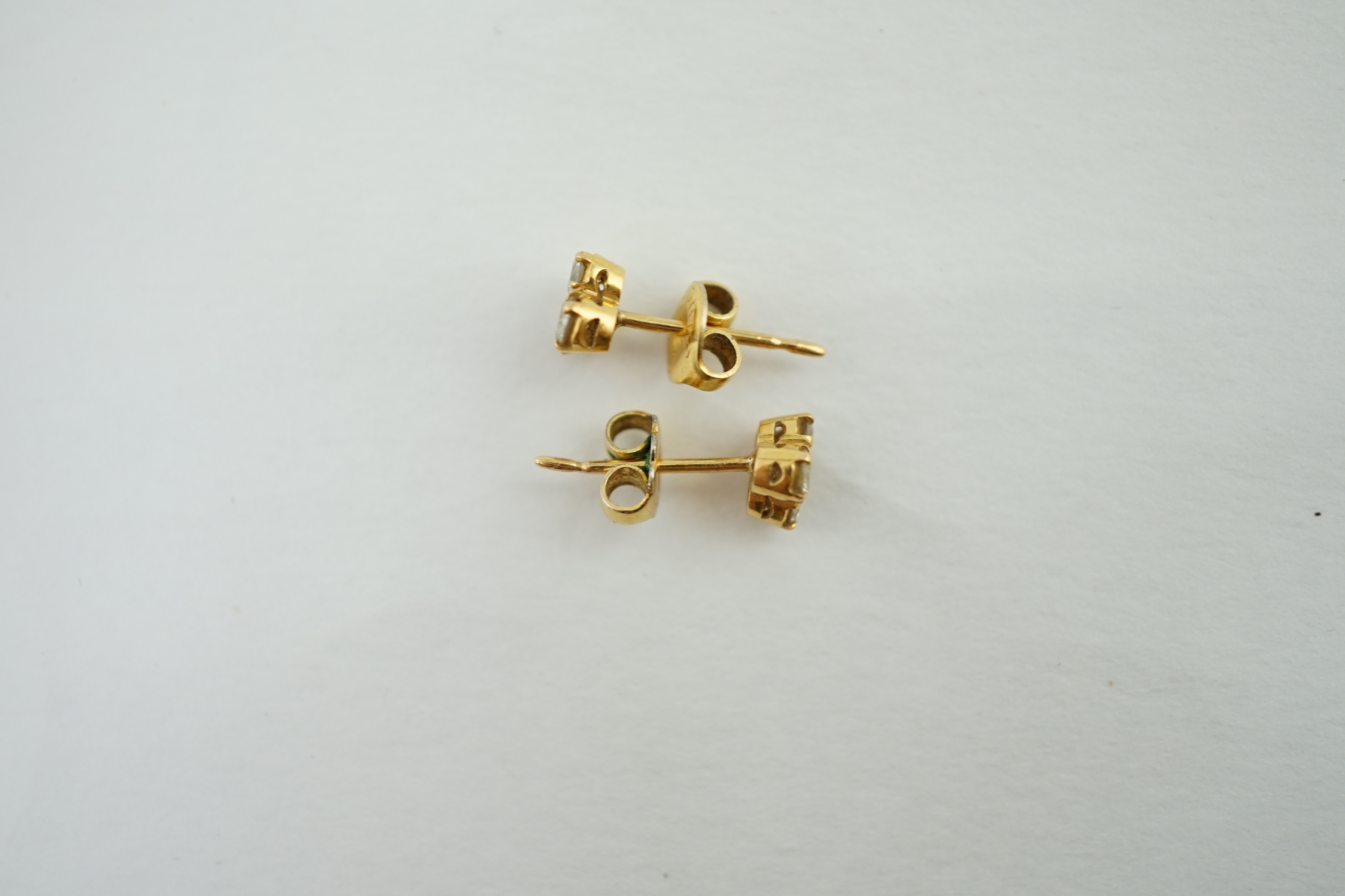 A pair of yellow metal and diamond ear studs